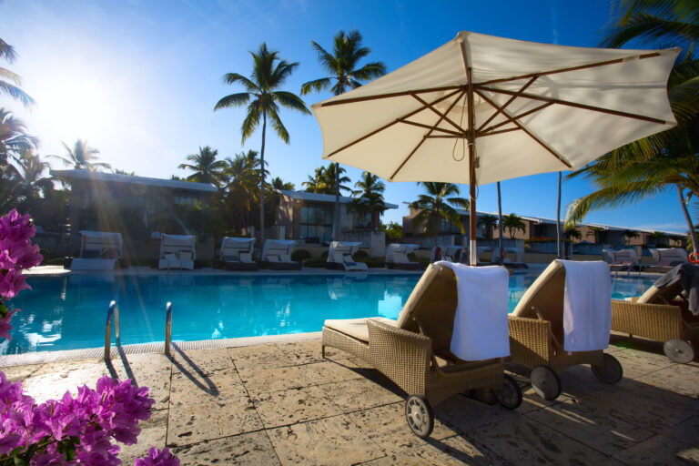 art Deckchairs in tropical resort hotel pool